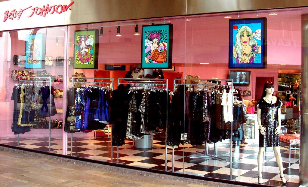 A boutique storefront window on a downtown street